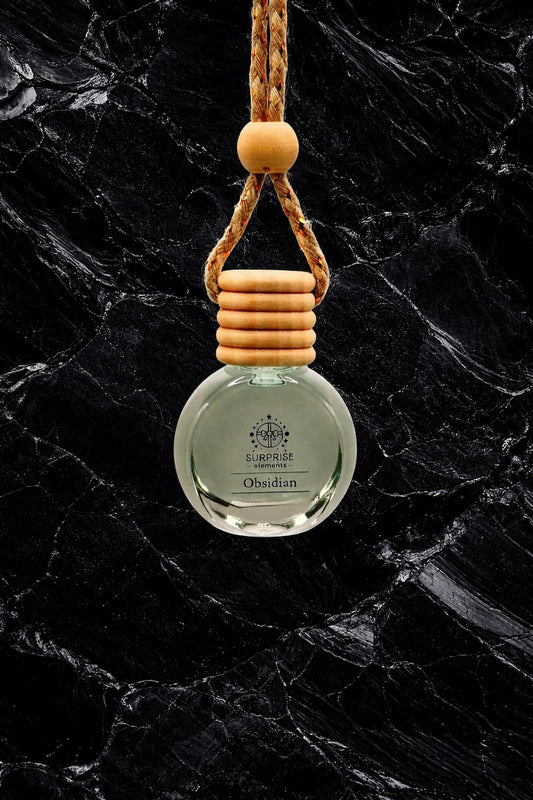 Car air freshener with wooden holder on a dark marble background