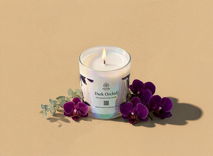 Candle with a 'Dark Orchid' label surrounded by purple flowers on a beige background 9oz jar coconut wax candle hand poured in Houston Texas 