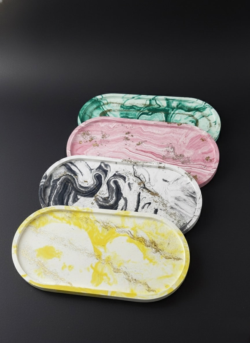 Set of five marble-patterned trays in various colors on a black background