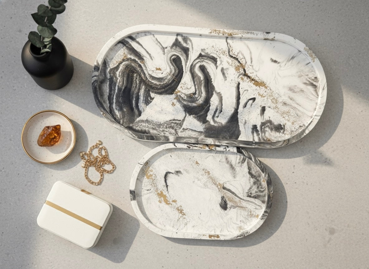 Marble-patterned jewelry box with gold accents on a gray surface