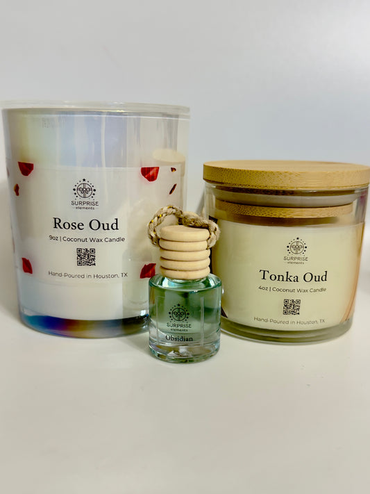 Two candles with different scents on a white background.
rose oud 9oz coconut wax candle 
tonka oud 4oz coconut wax candle 
obsidian car fragrance 
hand-poured in Houston Texas 