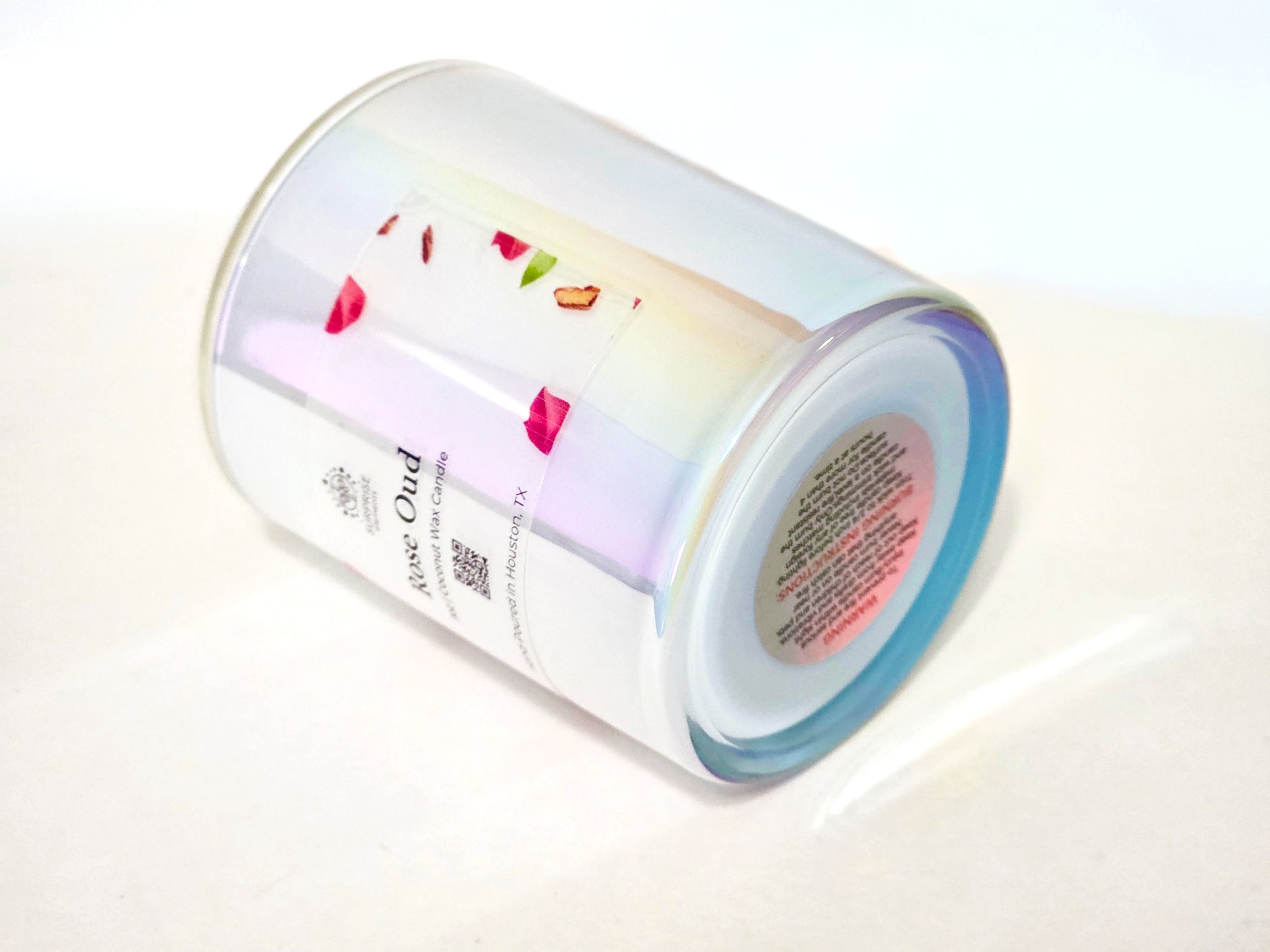 Cylindrical product with colorful design and warning label on a white background