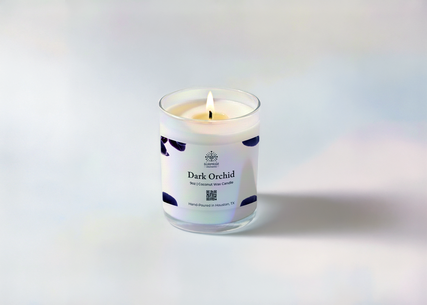 Candle labeled 'Dark Orchid' with a white label on a light gray background