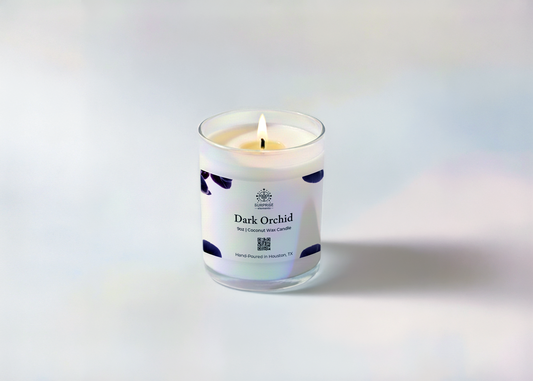 Candle labeled 'Dark Orchid' with a white label on a light gray background
