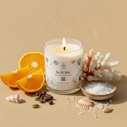 Candle labeled 'Se El Mar' with oranges, coral, and sea salt on a beige background 9oz coconut wax candle hand-poured in Houston Texas on the label 